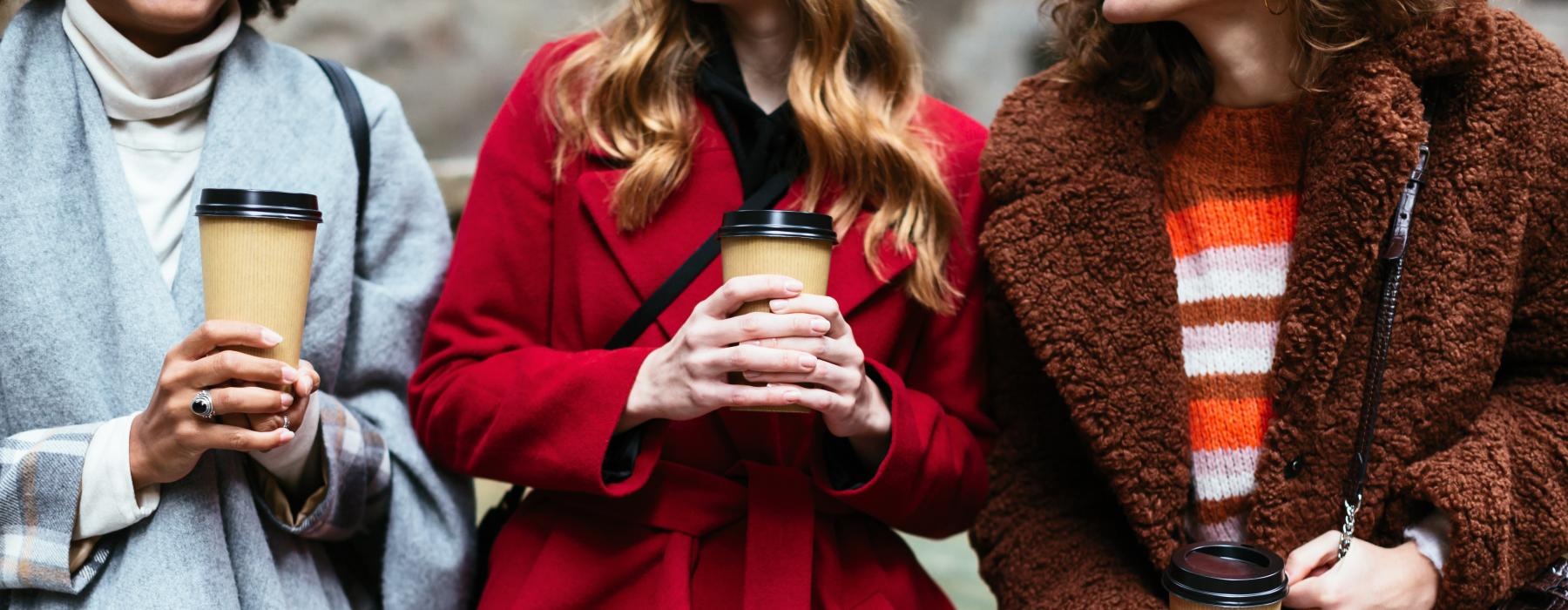 a group of people holding glasses of coffee